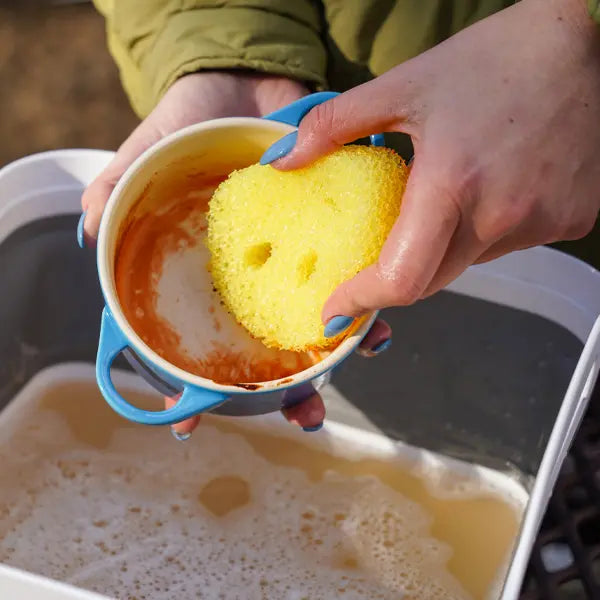 Yellow Scrub Daddy essentials cleaning a dirty cup